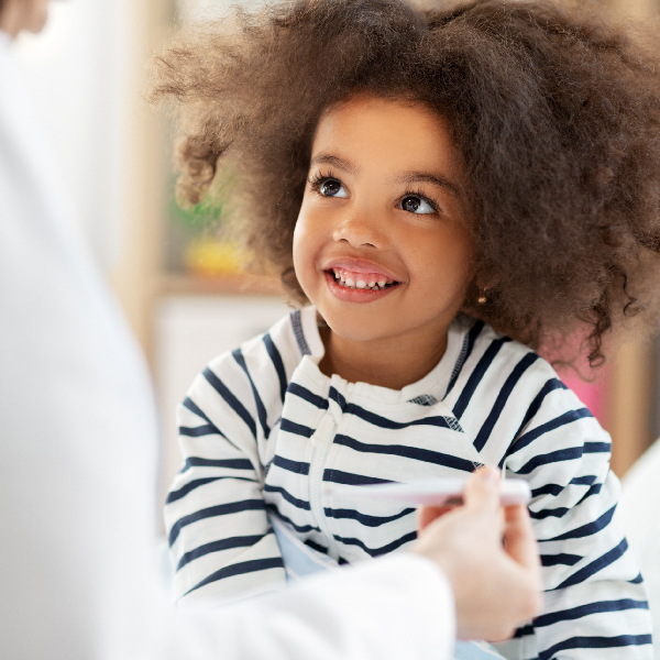 Image 2 (1) An office corner featuring a vibrant nature mural of a rocky river landscape, green walls, and a black chair. Natural light from a window.
